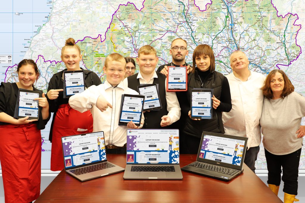 Volunteers at Summerhill Community Centre in Dumfries check out the new Cost-of-Living DG website, launched by the region’s Poverty and Inequalities Partnership.