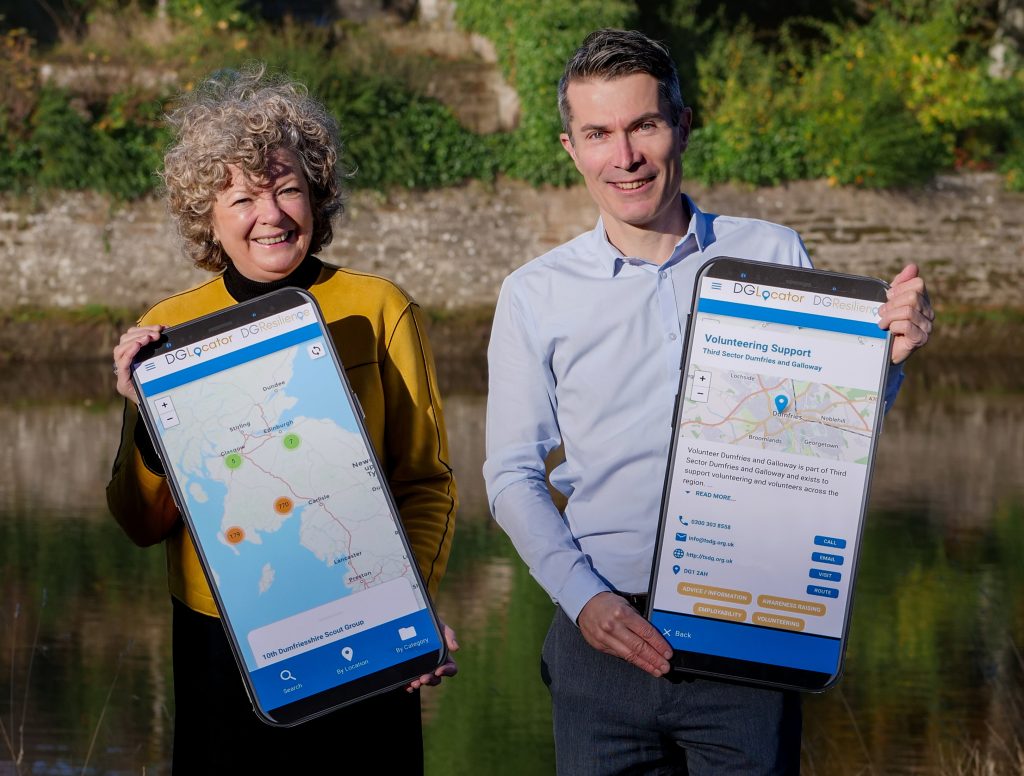 Norma Austin Hart, CEO at Third Sector Dumfries and Galloway, and Alan Hall, Communications Manager with screenshots of the new app.