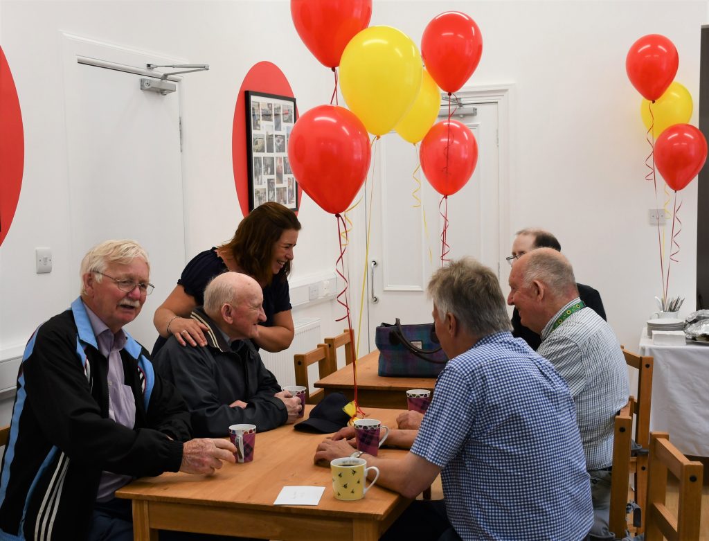 Food Train members and volunteers enjoy a cuppa and a cake at the official opening.