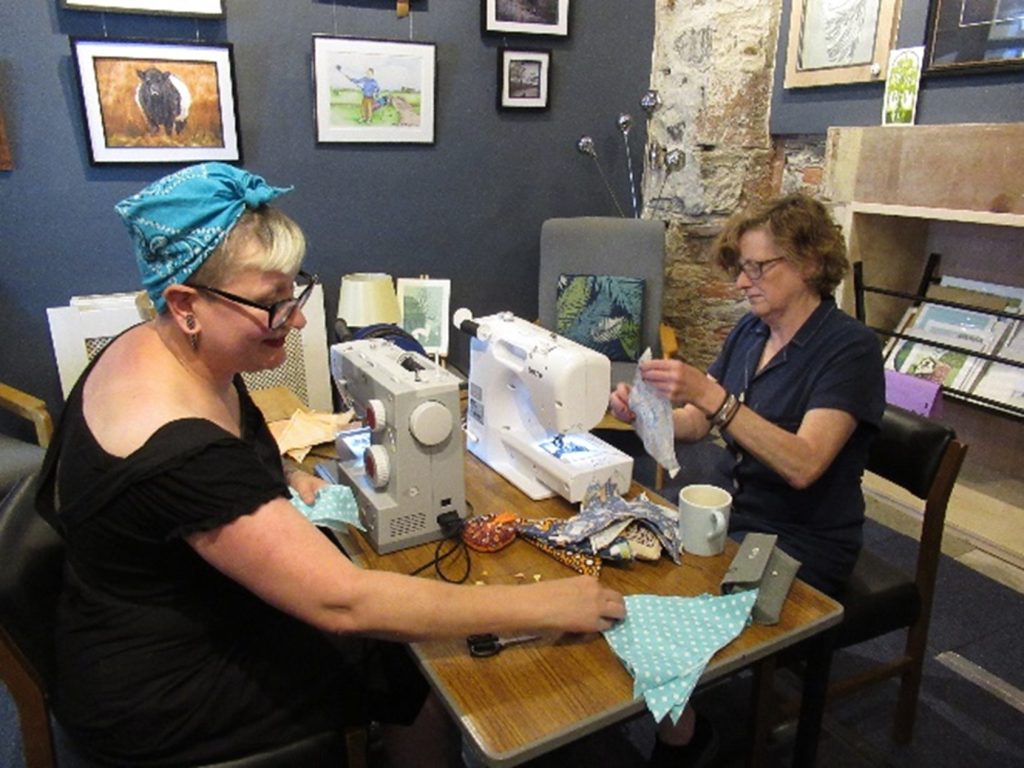 Members of Arty Craft making bunting from upcycled textiles at Moniaive.